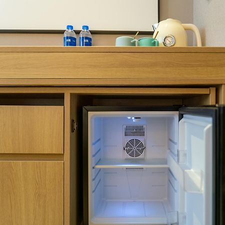 East Sacred Hotel--Very Near Beijing Tiananmen Square ,The Forbidden City,The Temple Of Heaven ,3 Minutes' Walk To Wangfujing Subway ,Located In The Center Of Beijing, Many Shopping Malls Around,Newly Renovated Hotel-Able To Receive Foreign Guests 外观 照片 A mini-refrigerator in a hotel room